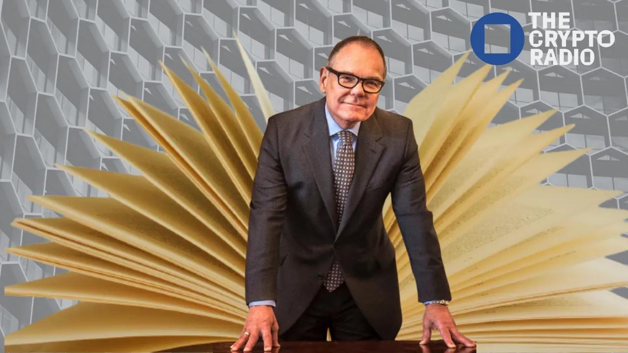 Don Tapscott standing in front of large, open book pages, appearing to discuss his upcoming work on AI and digital identity with The Crypto Radio