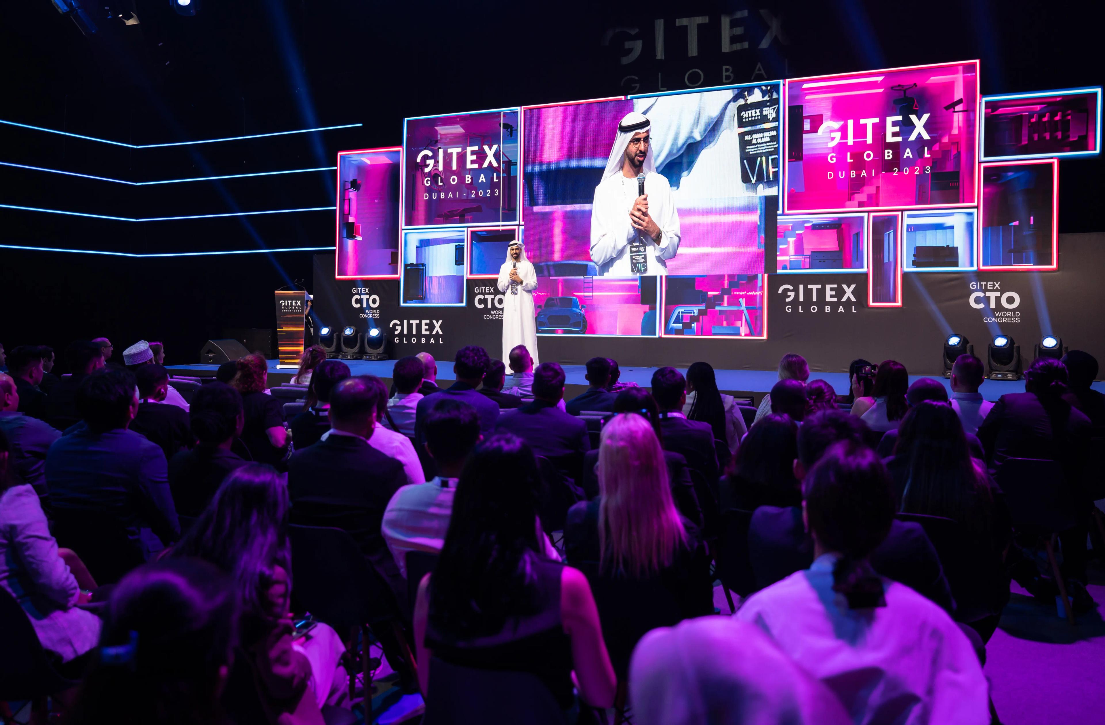 A crowd in front of a screen reading GITEX Global