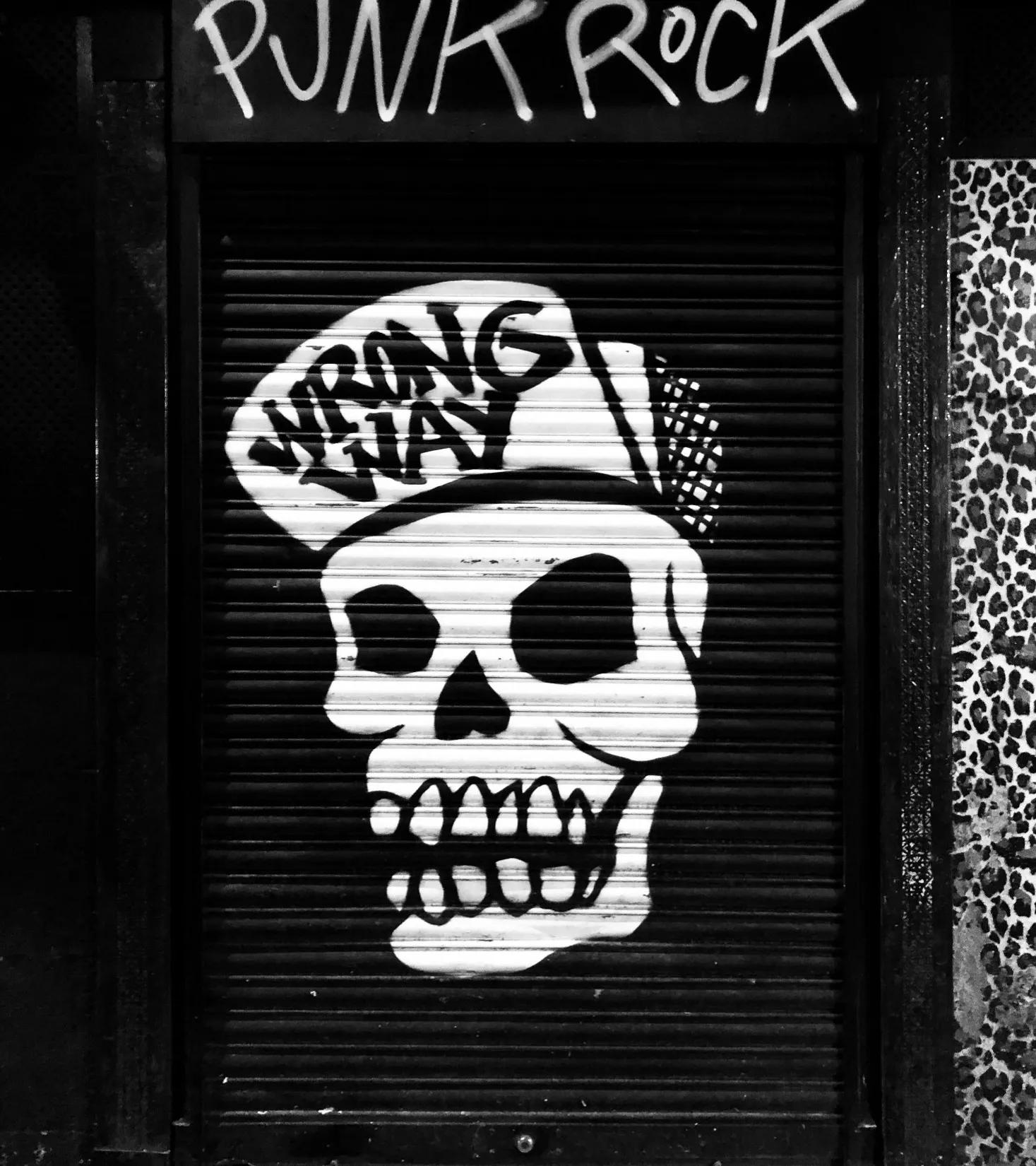 Graffiti of a skull with the writing punk rock and wrong way