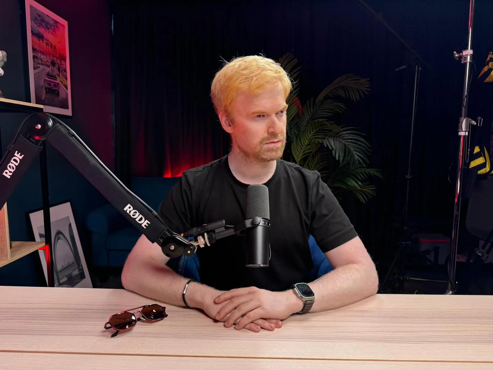 Rami Alame sitting in a studio with a microphone