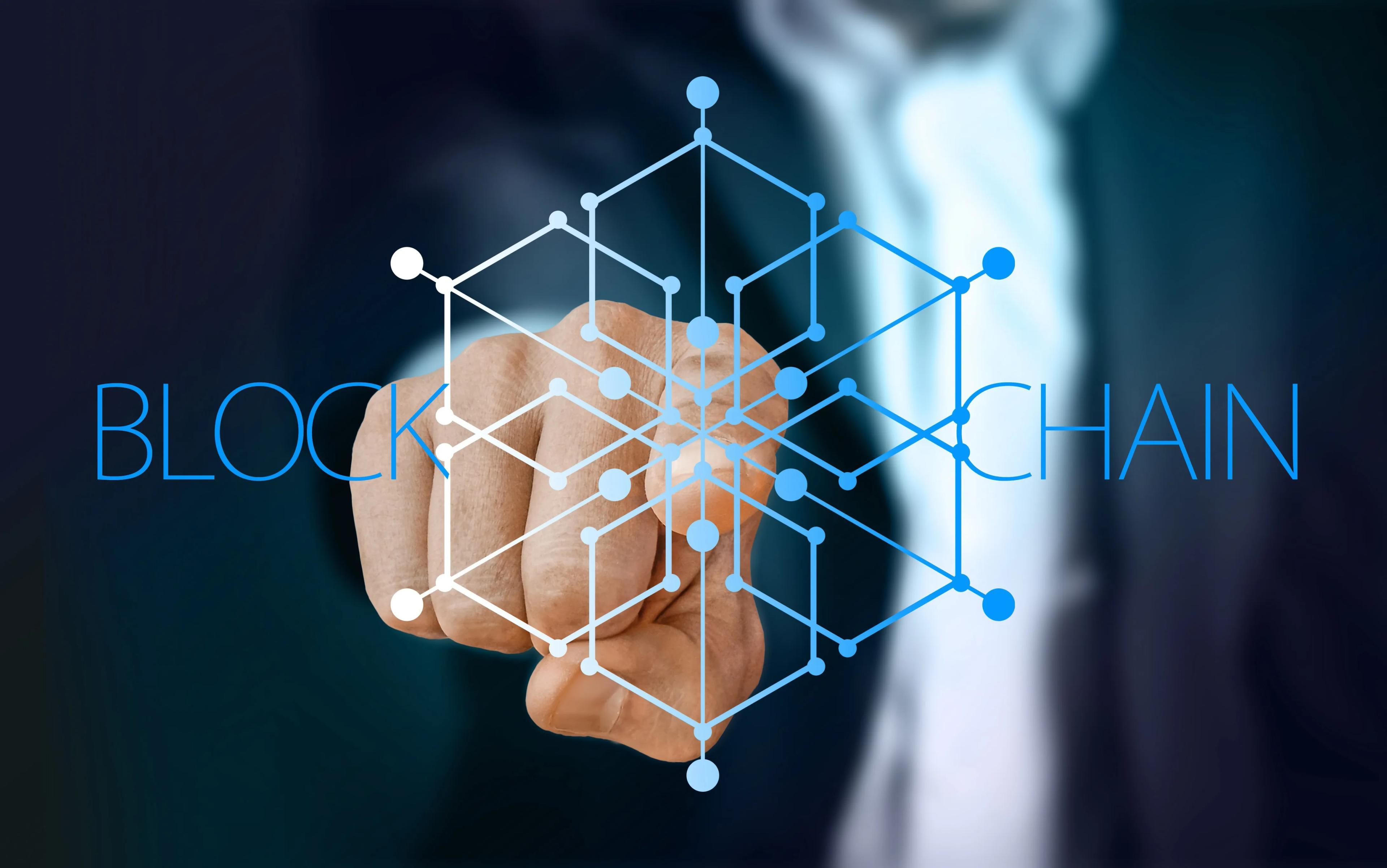 The word blockchain with a finger pointing at the reader