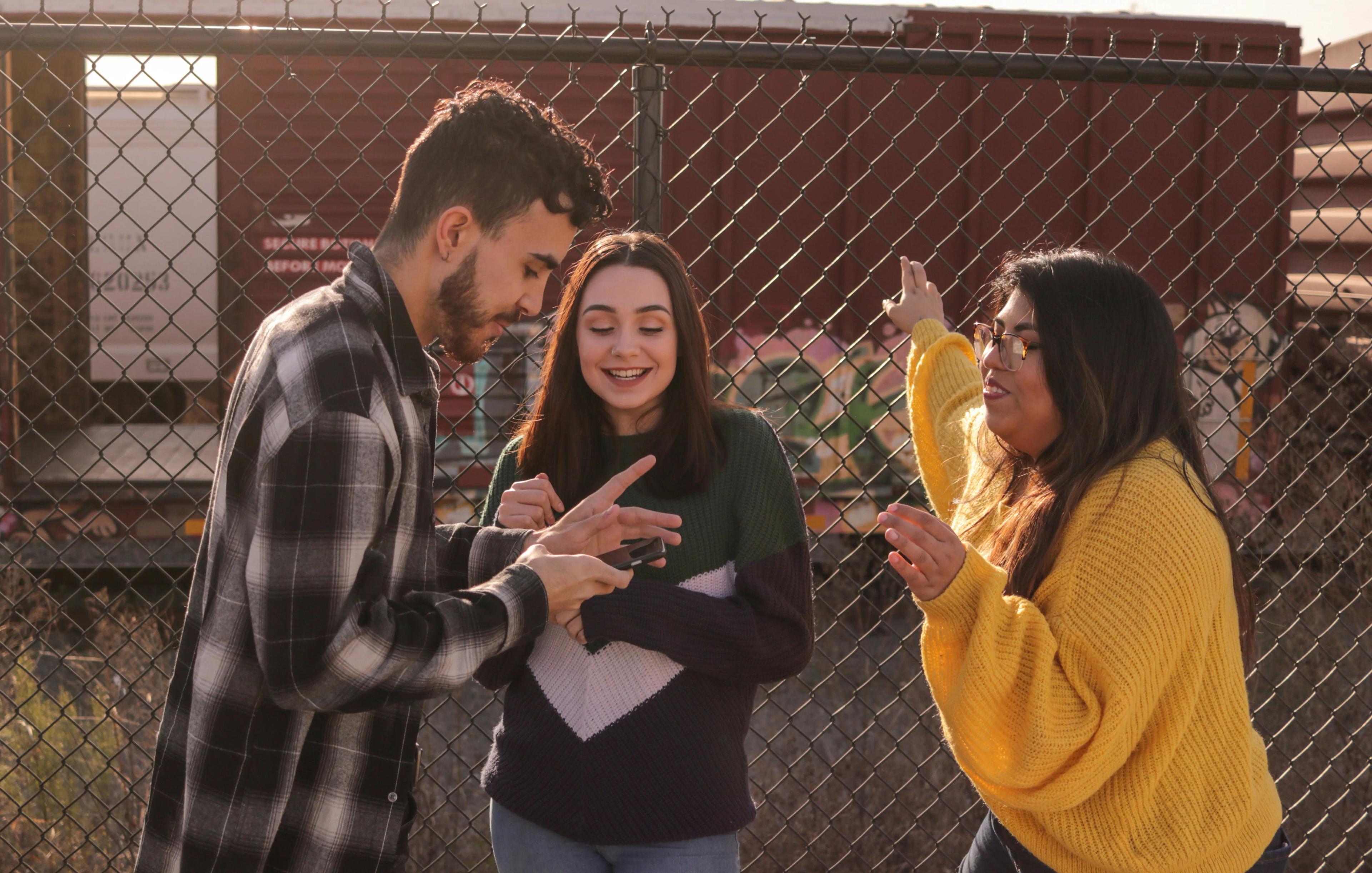 Teenagers socialise and use smartphone devices