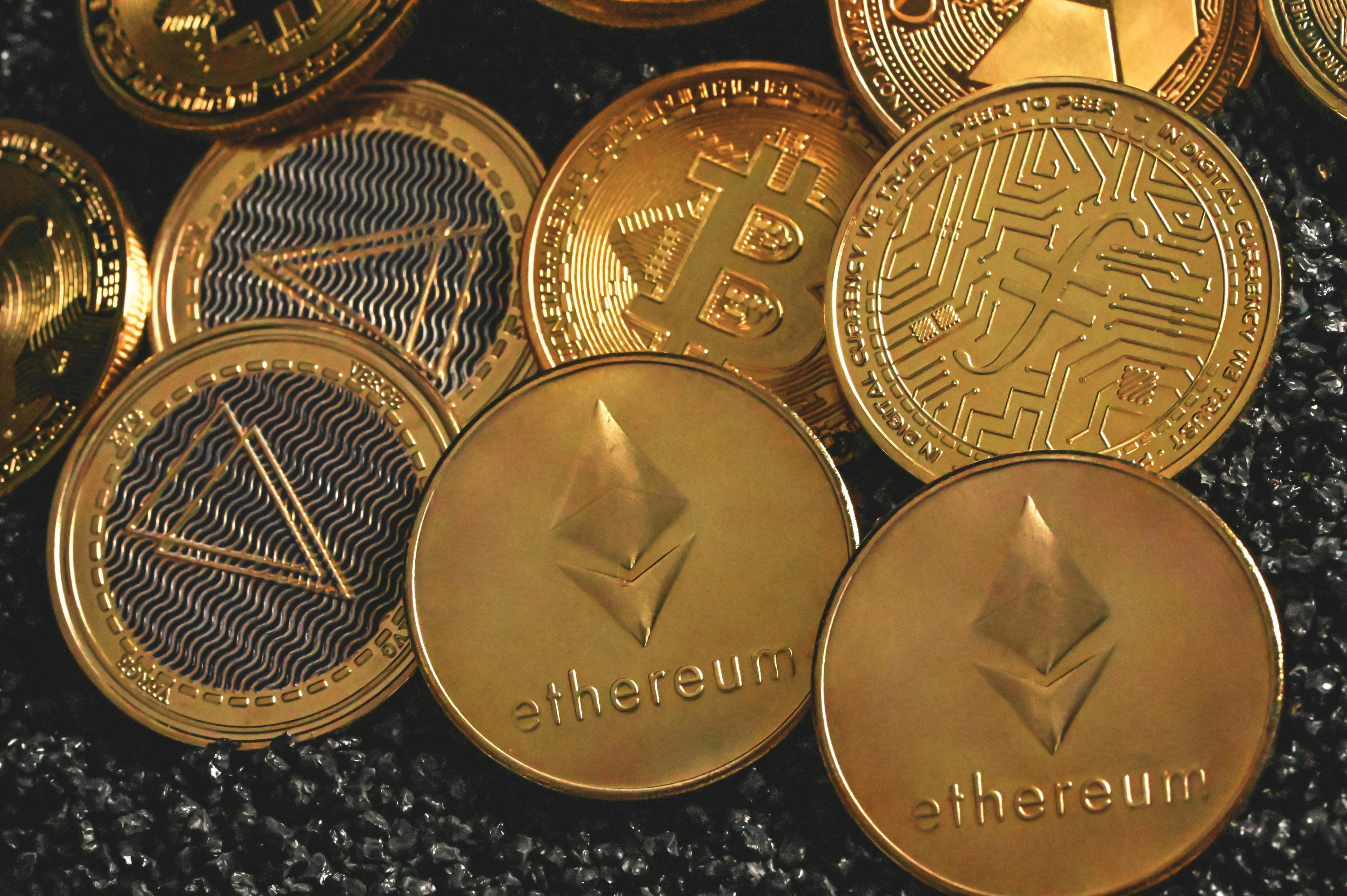 Crypto coins with names and logos of Ethereum and Bitcoin